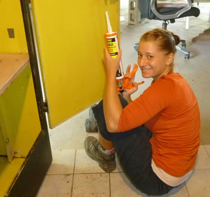 Eva  repairing a cupboard door